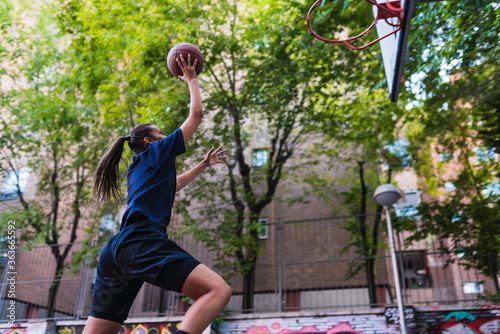 Female basketball player jumping photo