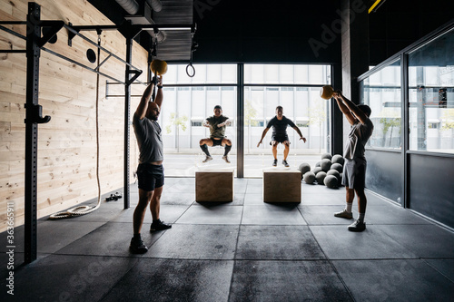 A group of men training in a crossfit box photo