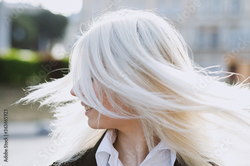 Young girl moving her blonde long hair.