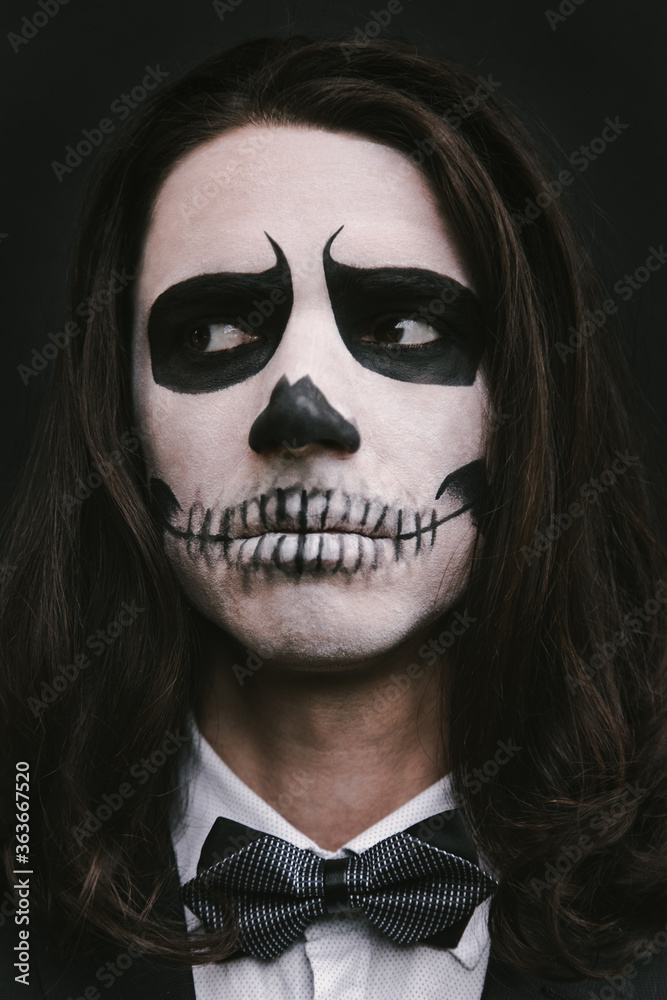 portrait of young man with skull Halloween facepaint portrait of young man with skull Halloween facepaint