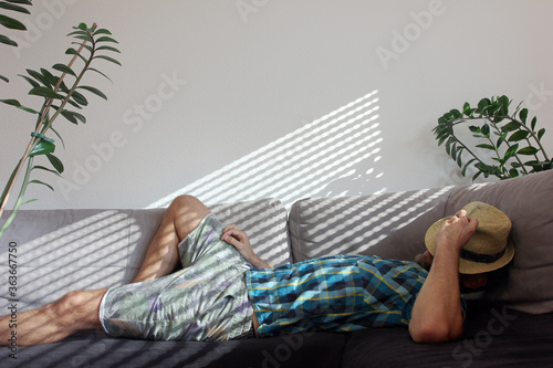 Relaxing on couch at home while summer heat