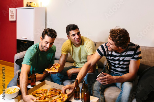 Friends watching a soccer match at home