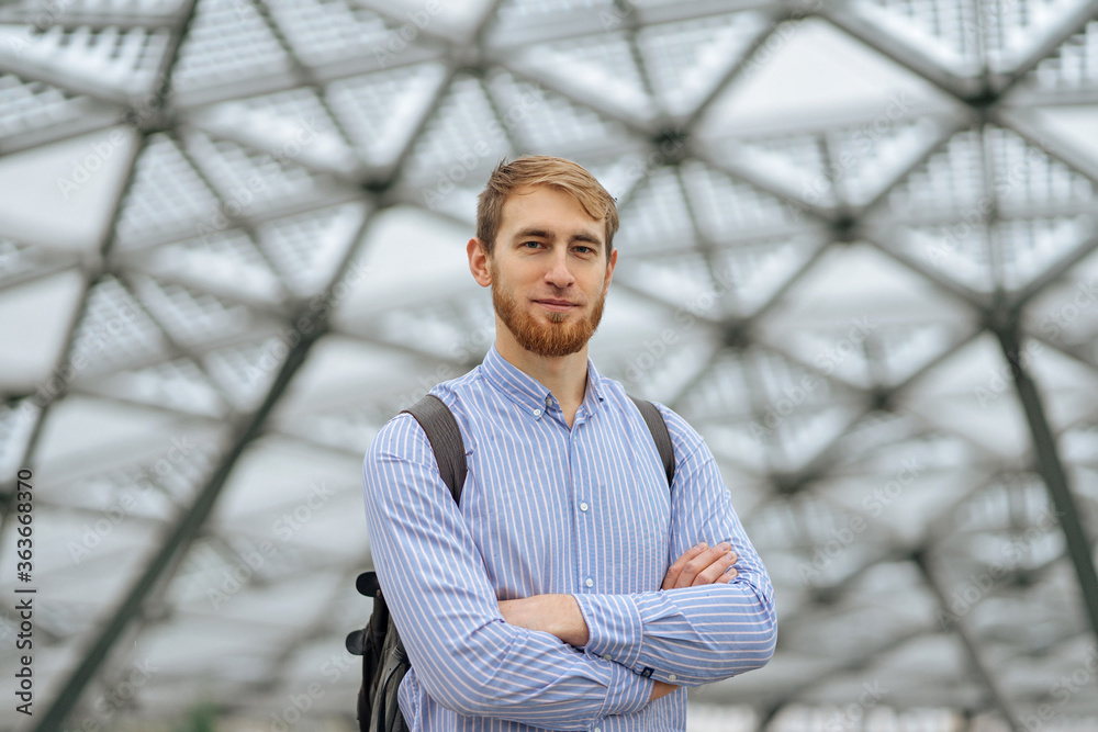 Handsome bearded male standing in modern building Handsome bearded male standing in modern building