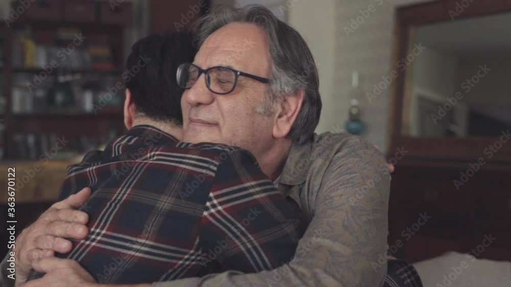 Young son embracing his father with love