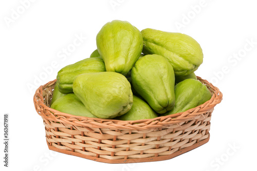 chayote in wicker basket on isolated white background
