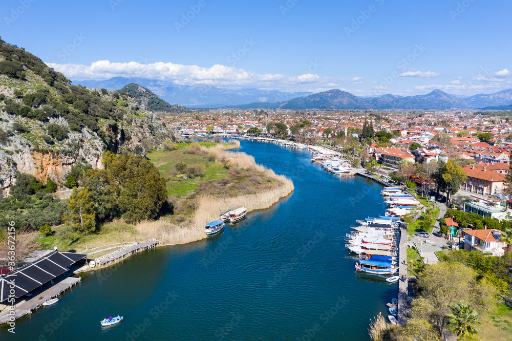 Dalyan canal view and settlement, excursion bout tour on Dalyan river valley. Dalyan is popular tourist destination in Turkey. Aerial view from drone.