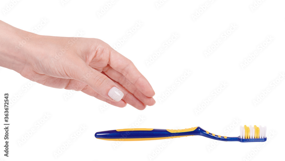 Hand with blue and yellow plastic toothbrush, dental care. Isolated on white background. Hand with blue and yellow plastic toothbrush, dental care. Isolated on white background.