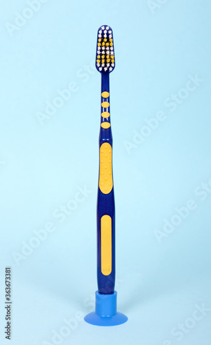Blue toothbrush, dental hygiene instrument. Isolated on blue background.
