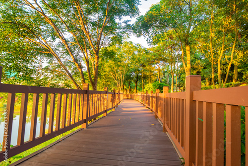 Outdoor park square with brick walkways and wooden paths at sunrise and sunset. © 一飞 黄