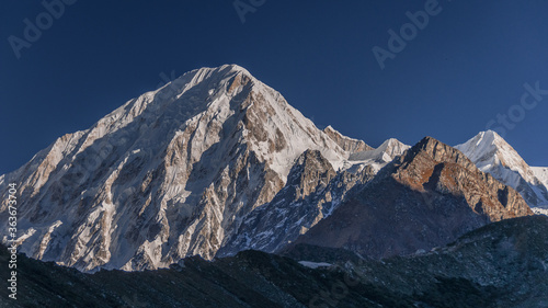 Cheo Himal & Himlung Himal stunning summits on Nepal-Tibet border as seen on descent from Larkya La pass to Bimtang village, Manaslu Circuit trek, Manaslu Himal, Gorkha district, Nepal Himalaya.