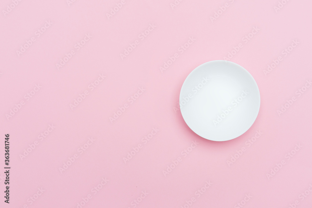 Empty white ceramic round plate isolated on pink Empty white ceramic round plate isolated on pink
