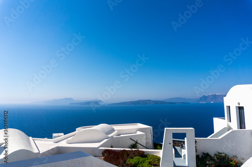 Roof top view of Santorini with the blue Mediterranean sea in the background