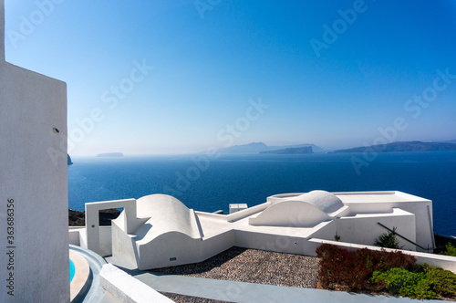 Roof top view of Santorini with the blue Mediterranean sea in the background