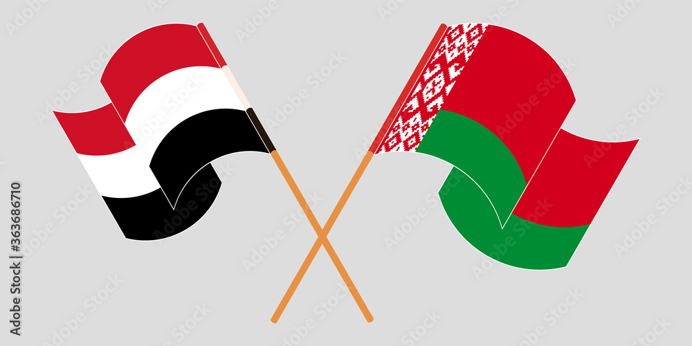 Crossed and waving flags of Belarus and Yemen