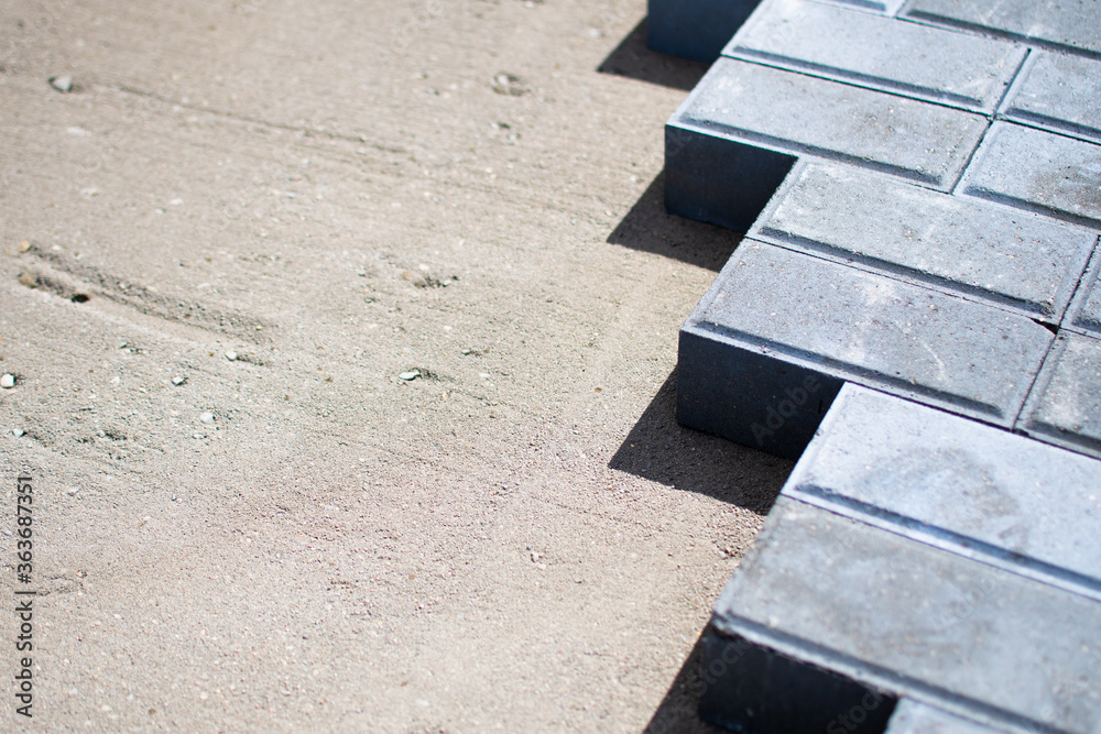 Landscaping of the yard with paving slabs, unfinished work on laying paving slabs. New paving