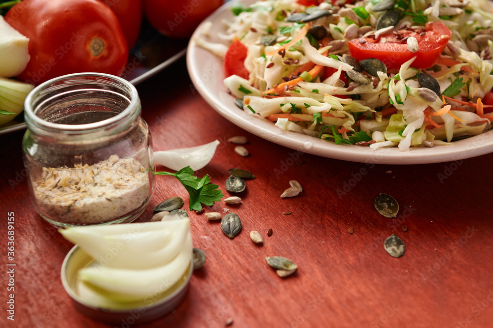 healthy food - fresh chopped vegetables on a wooden background, tomatoes and greens healthy food - fresh chopped vegetables on a wooden background, tomatoes and greens