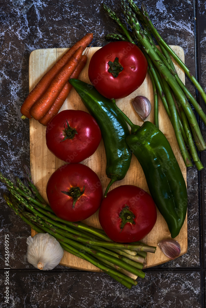 Vegetarian still life with tomatoes, green peppers, asparagus, carrots and garlic Vegetarian still life with tomatoes, green peppers, asparagus, carrots and garlic