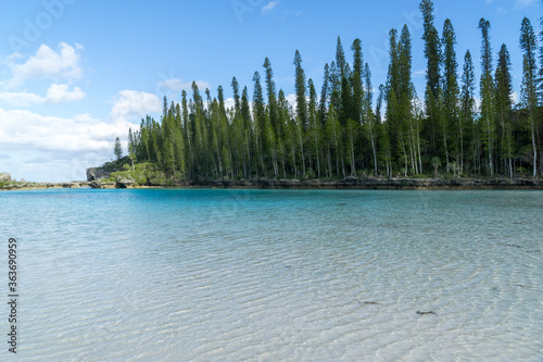 Beautiful seascape of natural swimming pool of Oro Bay, Isle of Pines, New Caledonia. aquamarine translucent water. 