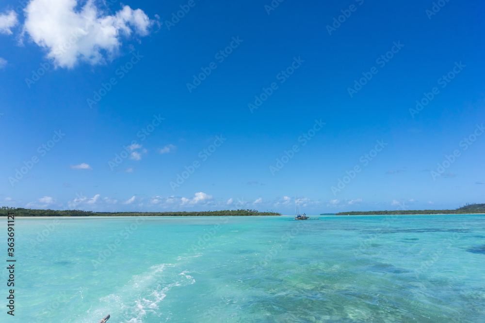 Beautiful seascape of Upi Bay, Pines Island, new caledonia: turquoise lagoon, lush vegetation, blue sky. 