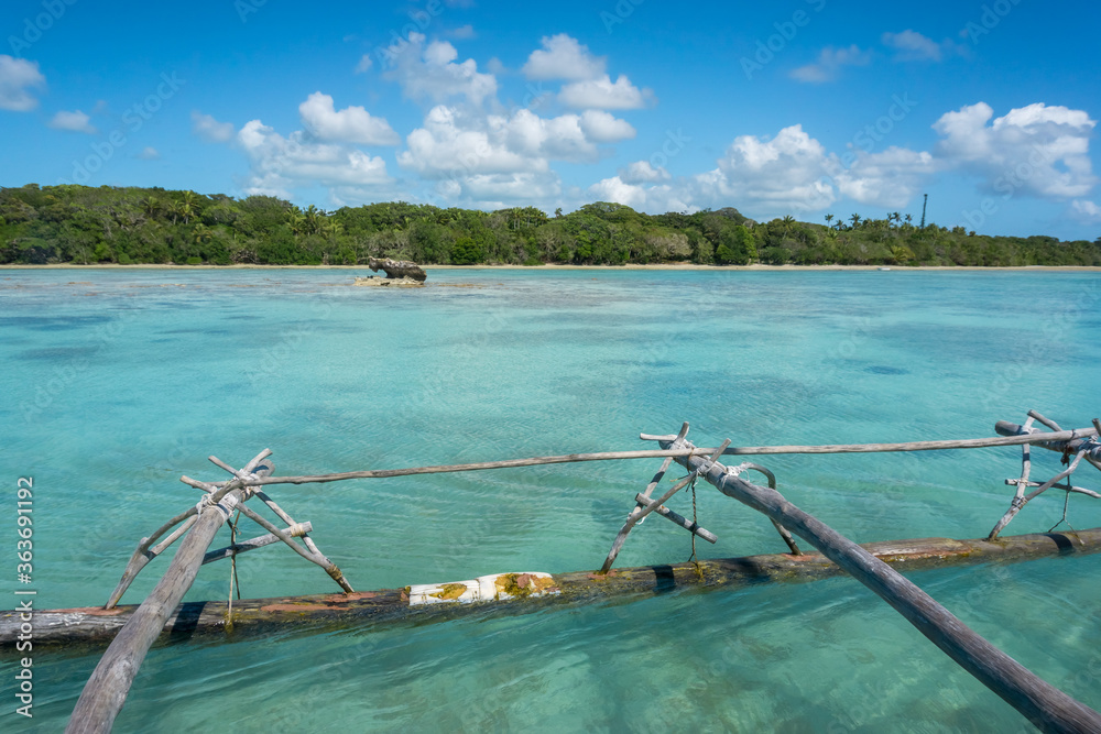 Boat trip on a traditional caledonian sailing boat in Upi bay, Isle of pines, New Caledonia. typical rocks in turquoise sea Boat trip on a traditional caledonian sailing boat in Upi bay, Isle of pines, New Caledonia. typical rocks in turquoise sea