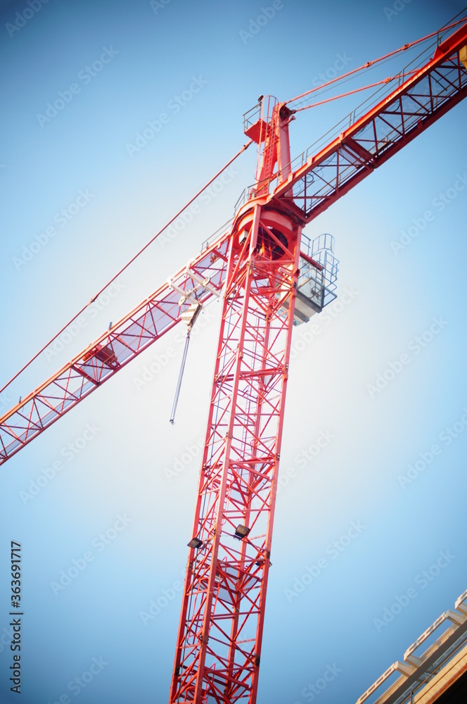 The crane working on the hotel. High construction, heavy lifting jib. Work at height during construction. The crane working on the hotel. High construction, heavy lifting jib. Work at height during construction.