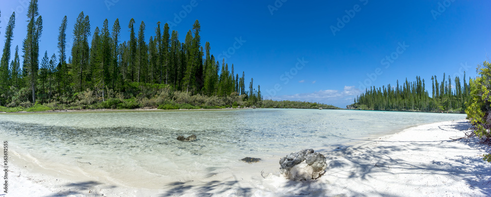 beautiful panoramic seascape of natural swimming pool of Oro Bay, Isle of Pines, New Caledonia. aquamarine translucent water.  Panoramic format