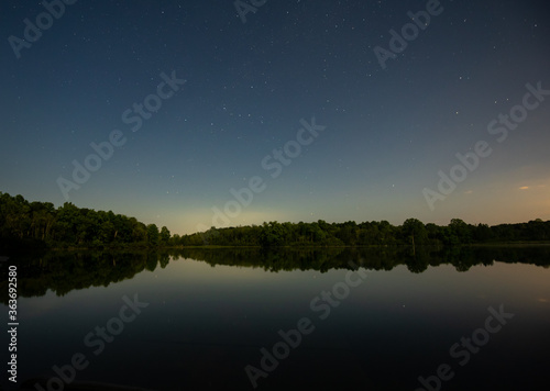 Secluded lake in a bright full moon night in summer Michigan