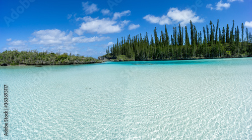 Beautiful seascape of natural swimming pool of Oro Bay, Isle of Pines, New Caledonia. aquamarine translucent water. 
