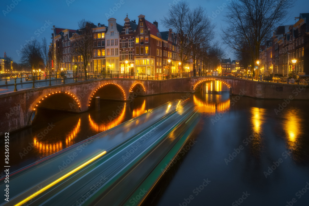 Amsterdam city canal old town, Netherlands. Beautiful iconic view illuminated at night