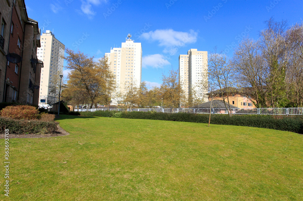 green space with high rise flats in view