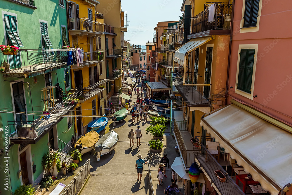 A view down the main street in the picturesque village of Manarola, Cinque Terre, Italy in the summertime