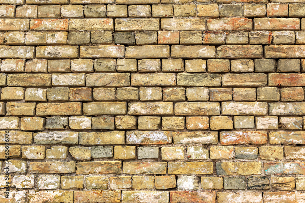 Obraz premium the old yellow brick wall