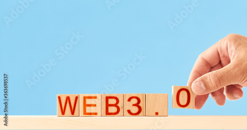 Fototapeta Naklejka Na Ścianę i Meble -  web 3.0 concept. man stacks wooden blocks labeled web 3.0