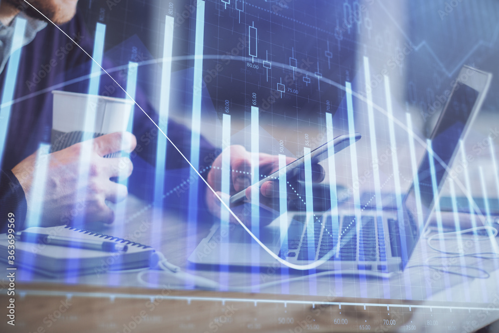 Double exposure of man's hands holding and using a phone and financial graph drawing. Analysis concept. Double exposure of man's hands holding and using a phone and financial graph drawing. Analysis concept.