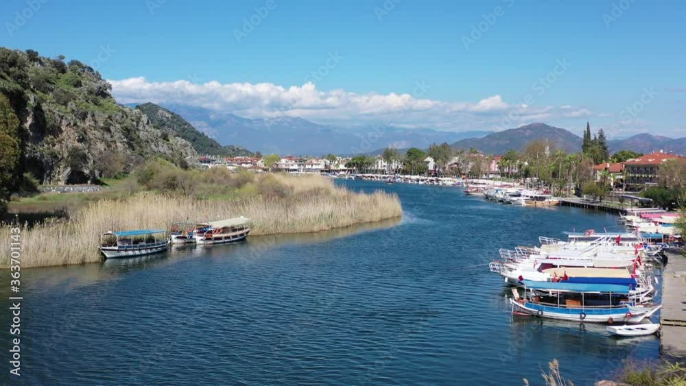Dalyan canal view and settlement, excursion bout tour on Dalyan river valley. Dalyan is popular tourist destination in Turkey. 4K Video Aerial view from drone. Dalyan canal view and settlement, excursion bout tour on Dalyan river valley. Dalyan is popular tourist destination in Turkey. 4K Video Aerial view from drone.