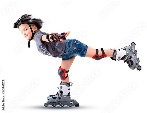 Five year old girl performs a roller skate trick