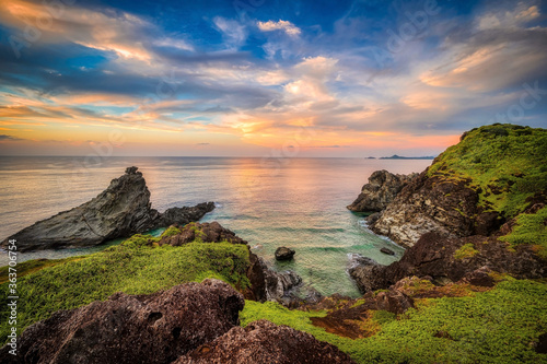 The rocky coastline and lighthouse of Ogan-zaki, Ishigaki Island, Okinawa, at sunset