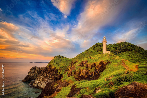 The rocky coastline and lighthouse of Ogan-zaki, Ishigaki Island, Okinawa, at sunset