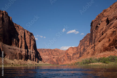 On the Colorado River floating through the rust colored Grand Canyon framed by the blue sky above