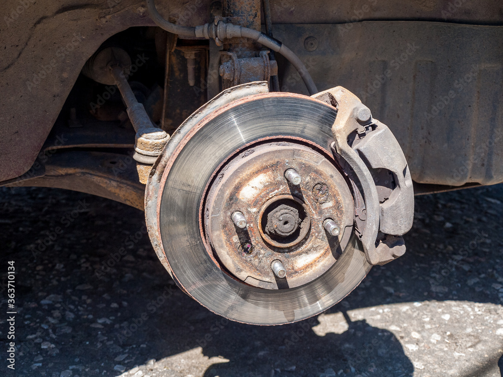 Car wheel with removed pneumatic tire and rim of the disk, visible connecting elements of the disk, hub and pneumatic tires, disassembly and repair of the car wheel..