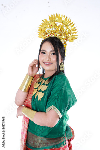 Beautiful smiling Asian girl wearing a set of modern traditional clothes  the traditional female outfits originated from Indonesia. Indonesian Women