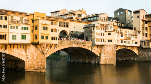 Photograph of a bridge on the Arno river in italy at sunset