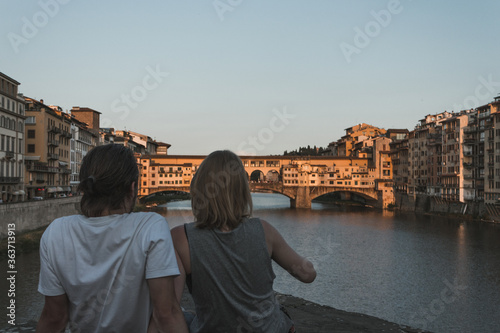 Photo of a couple on a bridge of the Arno river in italy at sunset © Alex Wolf 