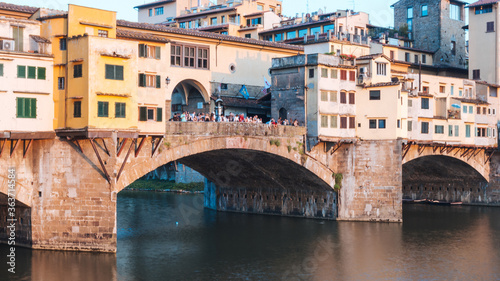 Photograph of a bridge on the Arno river in italy at sunset