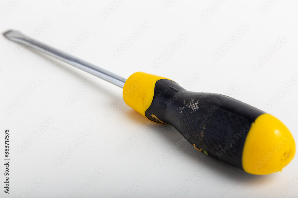 Used flathead screwdriver isolated on white background