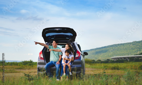 Asian family.happy little girl with family sitting in the car.Car insurance concept