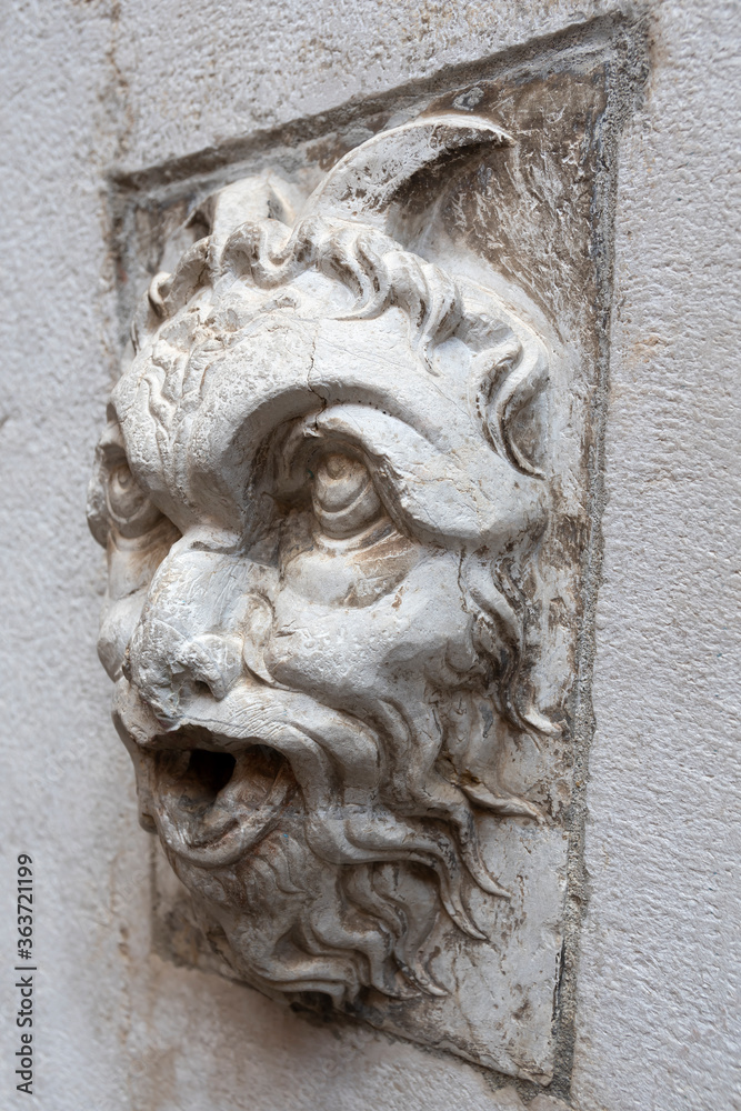 Bas-relief head positioned on a fountain located in Cortile Federico II - Piazza del Comune, Cremona