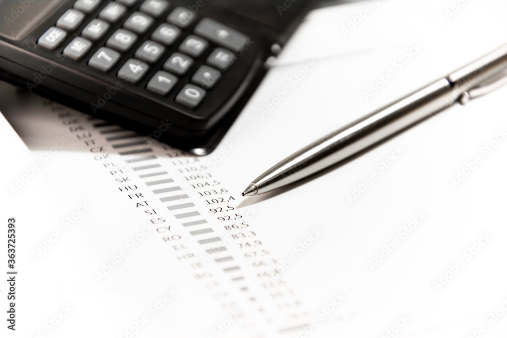 Pen and calculator on financial statement form. Finance concept. Pen and calculator on financial statement form. Finance concept.