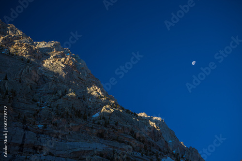 mountain landscape with moon in deep blue sky