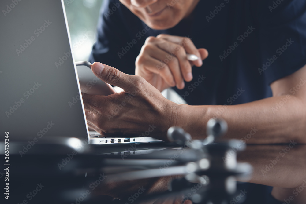 Ταπετσαρία asian doctor using mobile phone working on laptop computer for telemedicine or t